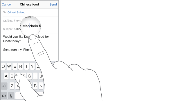 Finger touching the screen to get a magnified view of text and the insertion point.